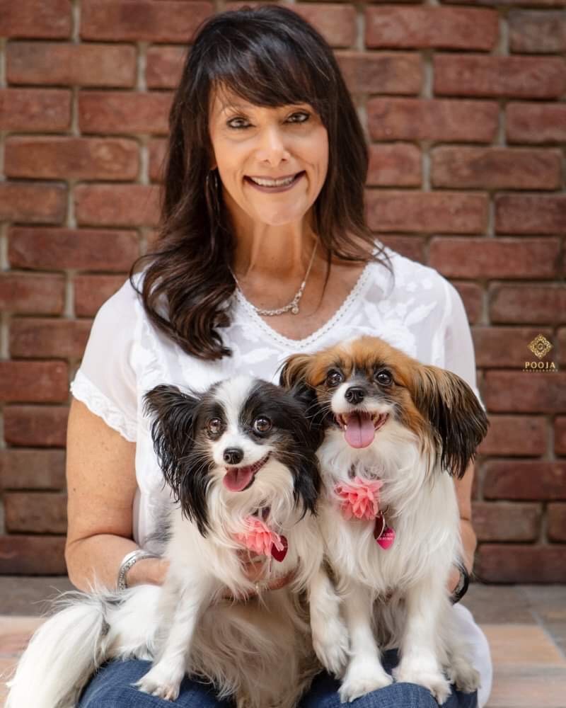 Puppy Love's founder Sabrina Freed holding her two dogs.