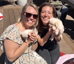 Two women and puppies.