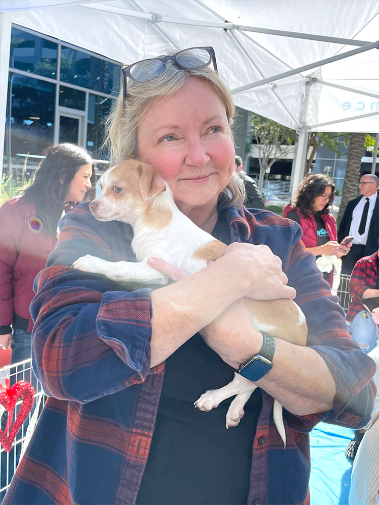 A Puppy Love event in Los Angeles to San Diego with someone holding and loving a beautiful puppy!