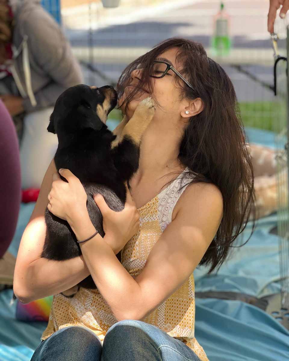 Ebay employee enjoying Puppy Love™ Las Vegas's puppy experience as part of incorporating ideas for wellness at work.