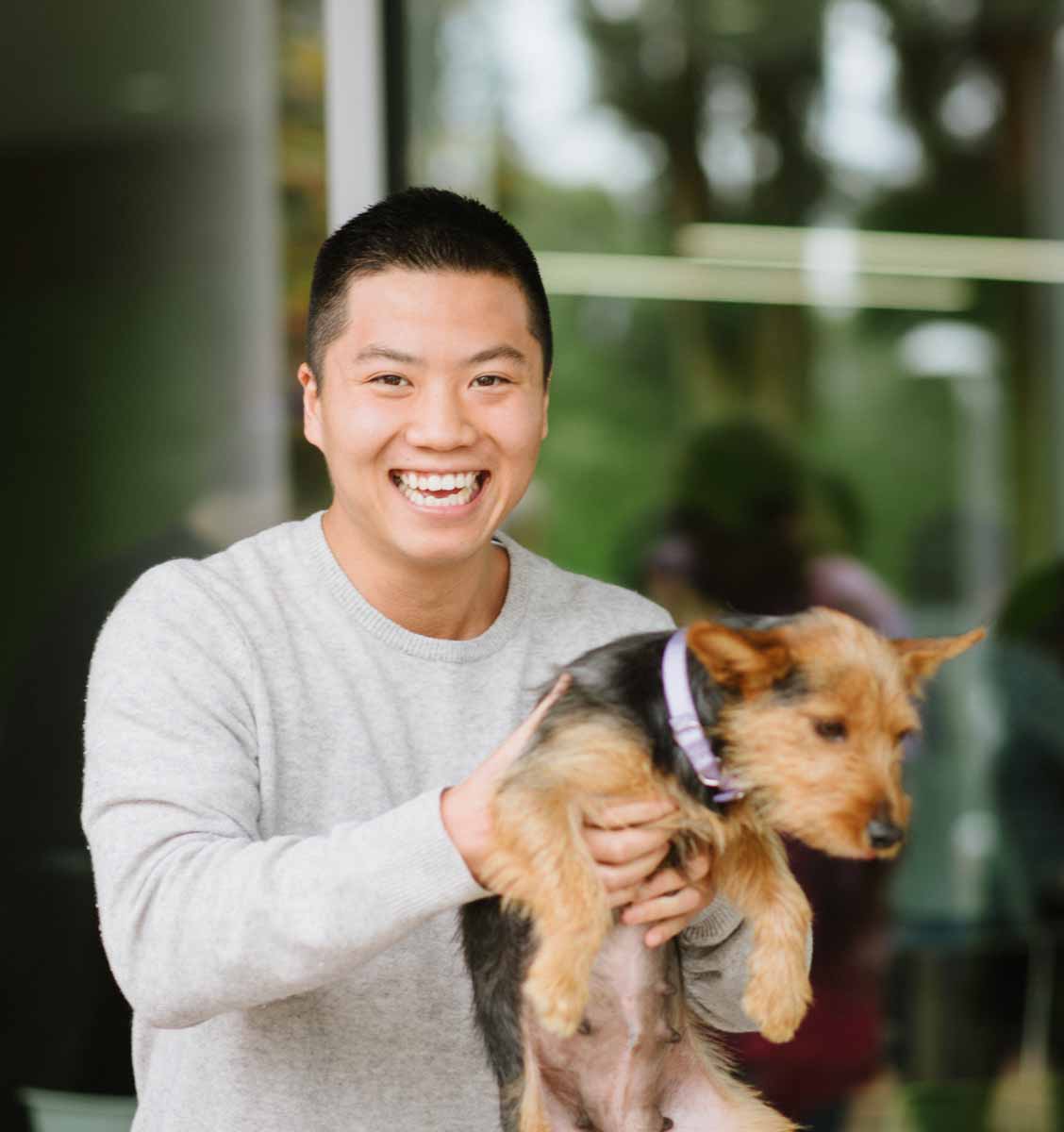 This adorable puppy and employee have fun at a corporate wellness event with Puppy Love!.