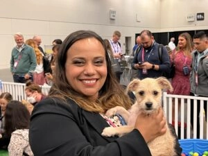 Pure Joy At A Gainsight Pulse 2022 3 A women and a white puppy.
