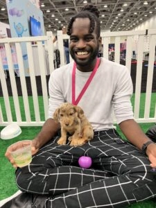 Pure Joy At A Gainsight Pulse 2022 1 A man in a white shirt with a golden puppy