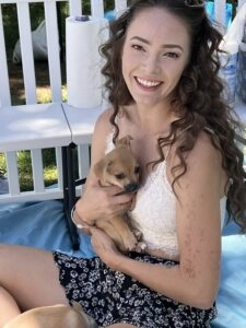 Cute black and white puppy with a woman.