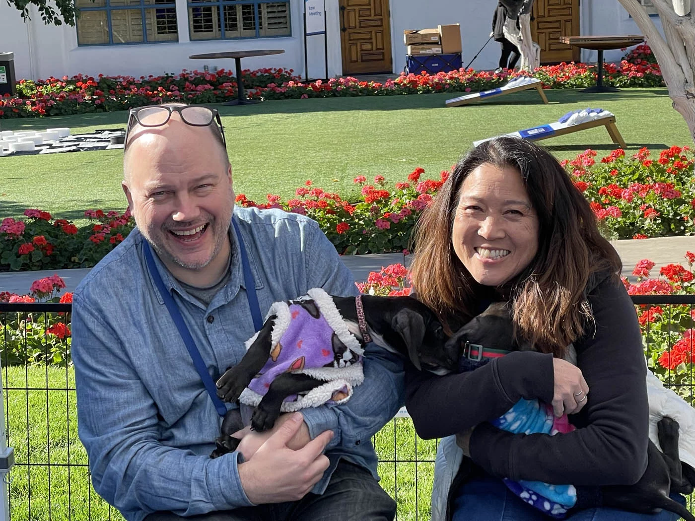 15 Puppy Love people holding puppies at Amgen 2024 Conference