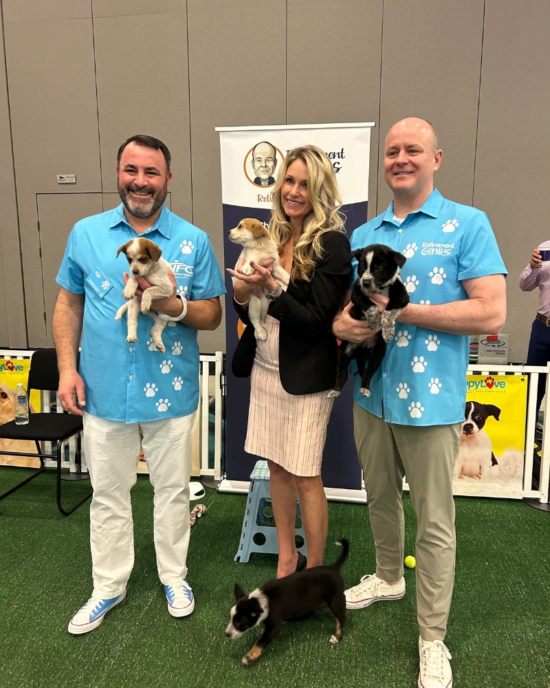 IFC National Marketing and Wagging Tails Rescue pictured with eight-week old cattle dog mix puppies at MedicareCon