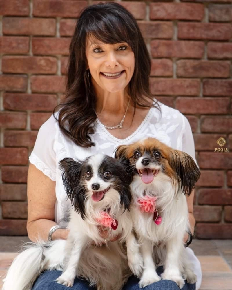 The-Girls Puppy love™'s founder sabrina freed holding her two dogs.
